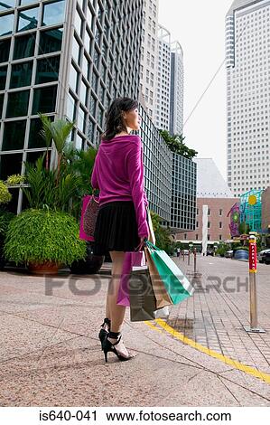 Woman carrying shopping bags View Large Photo Image Stock Image - Woman carrying shopping bags. Fotosearch