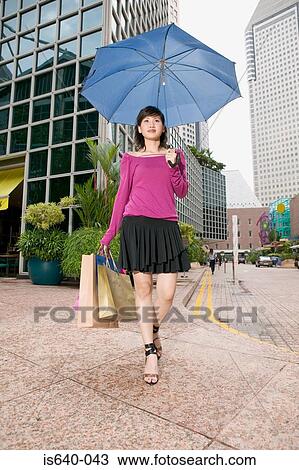 Stock Image - Woman carrying shopping bags. Fotosearch