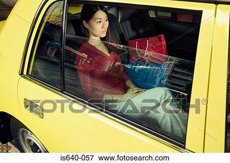 Stock Photo - Woman in a taxicab. Fotosearch