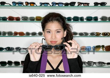 Woman shopping for sunglasses View Large Photo Image Stock Photography - Woman shopping for sunglasses. Fotosearch