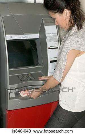 Woman using a cash machine View Large Photo Image Stock Image - Woman using a cash machine. Fotosearch