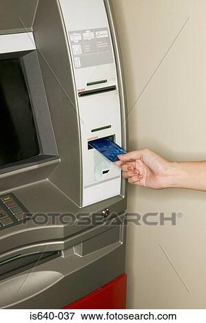 Stock Photo - Woman using a cash machine. Fotosearch