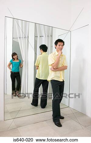 Young couple in clothes store View Large Photo Image Stock Image - Young couple in clothes store. Fotosearch