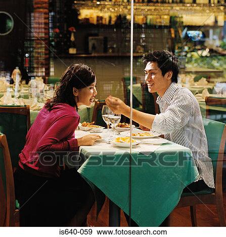 Stock Photo - Young couple in restaurant. Fotosearch