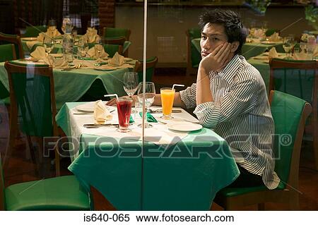Young man waiting in restaurant View Large Photo Image Stock Photography - Young man waiting in restaurant. Fotosearch