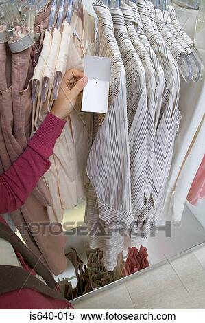 Young woman in clothes store View Large Photo Image Stock Photography - Young woman in clothes store. Fotosearch