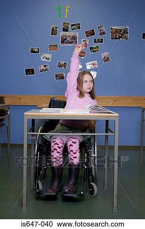 Stock Image - Disabled girl in classroom. Fotosearch
