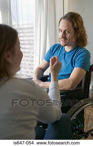 Disabled man and partner in apartment View Large Photo Image Picture - Disabled man and partner in apartment. Fotosearch