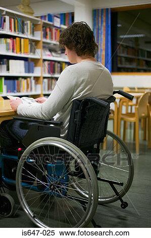 Disabled man reading in library View Large Photo Image Stock Photography - Disabled man reading in library. Fotosearch