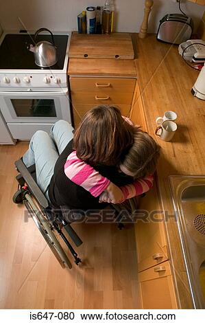 Disabled mother and daughter hugging View Large Photo Image Stock Image - Disabled mother and daughter hugging. Fotosearch