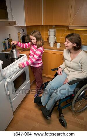 Disabled mother and daughter in kitchen View Large Photo Image Picture - Disabled mother and daughter in kitchen. Fotosearch