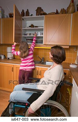 Disabled mother and daughter in kitchen View Large Photo Image Stock Image - Disabled mother and daughter in kitchen. Fotosearch