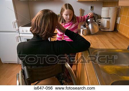 Disabled mother and daughter in kitchen View Large Photo Image Stock Photograph - Disabled mother and daughter in kitchen. Fotosearch