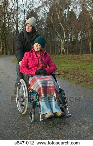 Disabled woman and partner in park View Large Photo Image Stock Image - Disabled woman and partner in park. Fotosearch