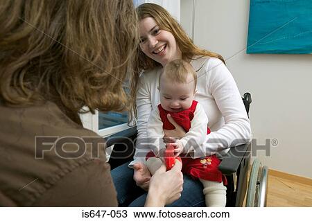 Stock Image - Disabled woman with baby. Fotosearch