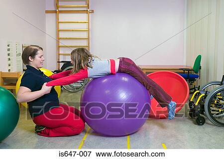 Stock Photo - Girl exercising on fitness ball. Fotosearch