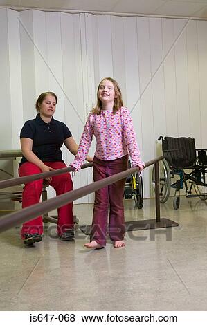 Stock Photo - Girl walking using support bars. Fotosearch