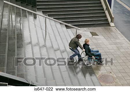 Man helping disabled person up stairway View Large Photo Image Stock Image - Man helping disabled person up stairway. Fotosearch