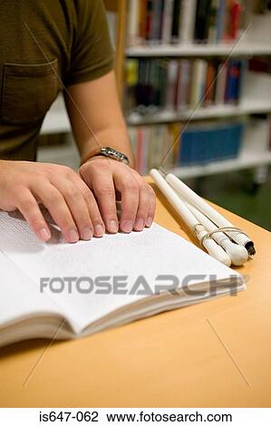 Young man reading braille View Large Photo Image Stock Image - Young man reading braille. Fotosearch