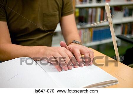 Young man reading braille View Large Photo Image Stock Image - Young man reading braille. Fotosearch