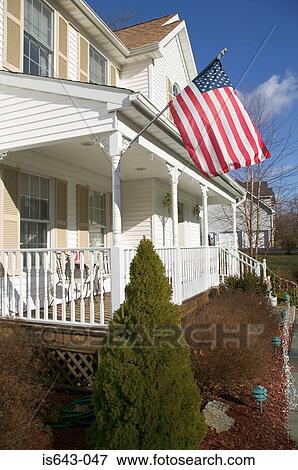American flag outside house View Large Photo Image Stock Photo - American flag outside house. Fotosearch