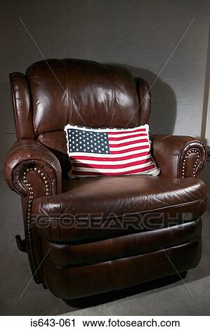 Stock Image - Armchair with stars and stripes cushion. Fotosearch
