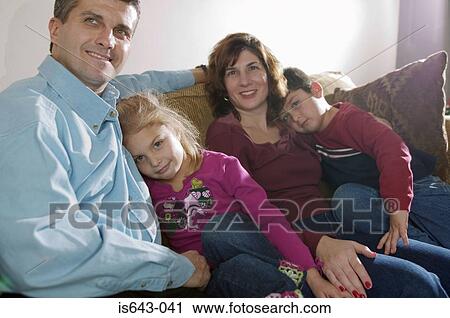 Stock Image - Family resting on the sofa. Fotosearch