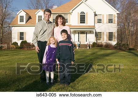 Family standing outside their house View Large Photo Image Stock Photography - Family standing outside their house. Fotosearch
