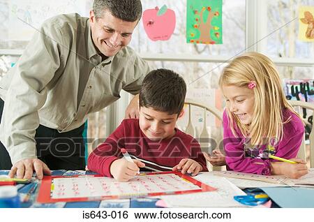 Stock Photograph - Father helping children with homework. Fotosearch
