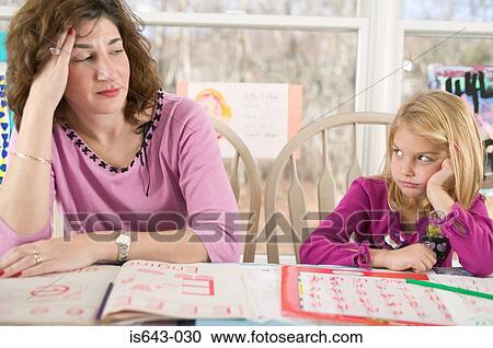 Frustrated mother helping bored daughter with homework View Large Photo Image Stock Image - Frustrated mother helping bored daughter with homework. Fotosearch