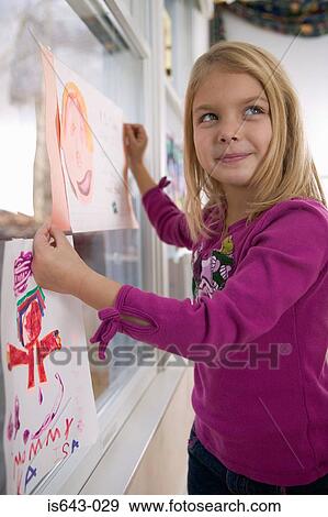 Girl holding drawing of face View Large Photo Image Stock Photo - Girl holding drawing of face. Fotosearch