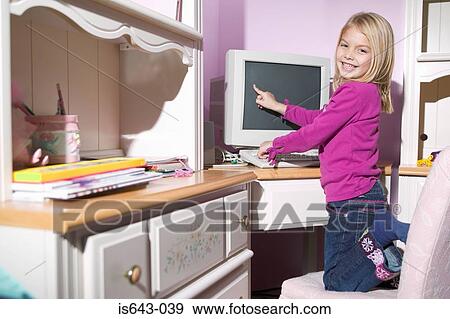 Girl pointing at computer screen View Large Photo Image Stock Photo - Girl pointing at computer screen. Fotosearch
