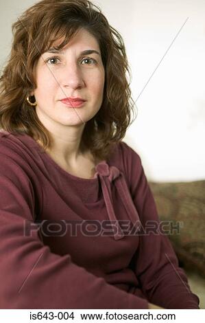 Mid adult woman looking at camera View Large Photo Image Picture - Mid adult woman looking at camera. Fotosearch