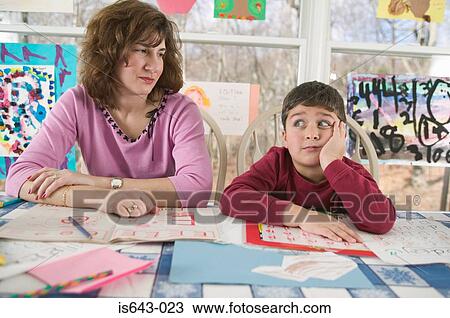 Mother helping bored son with homework View Large Photo Image Stock Image - Mother helping bored son with homework. Fotosearch