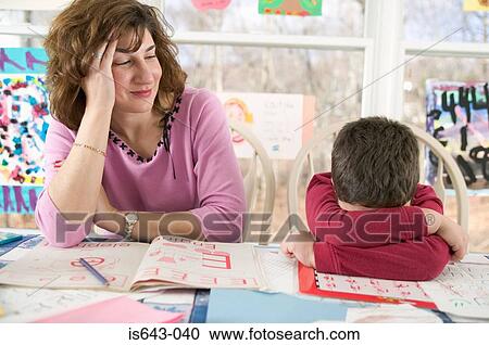 Mother helping tired son with homework View Large Photo Image Stock Image - Mother helping tired son with homework. Fotosearch