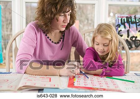 Mother teaching daughter View Large Photo Image Stock Photo - Mother teaching daughter. Fotosearch