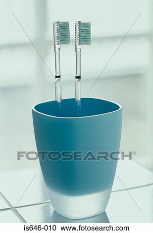 Two toothbrushes in a cup View Large Photo Image Stock Image - Two toothbrushes in a cup. Fotosearch