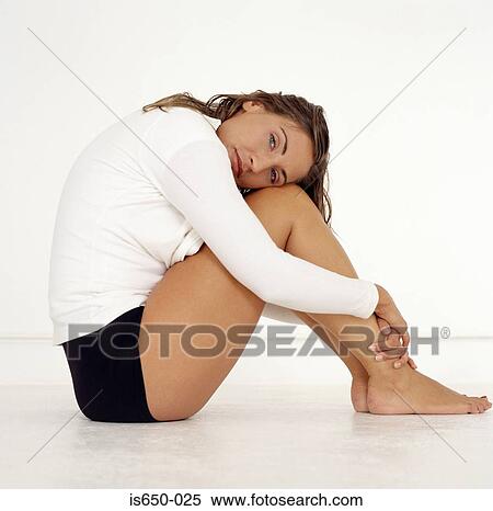Woman hugging her knees View Large Photo Image Stock Photography - Woman hugging her knees. Fotosearch