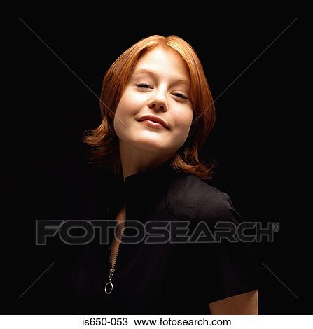 Stock Image - Young red-headed woman. Fotosearch