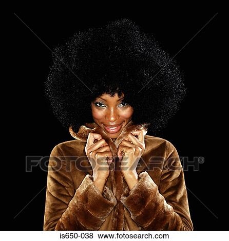 Stock Photo - Young woman in fur coat with afro. Fotosearch