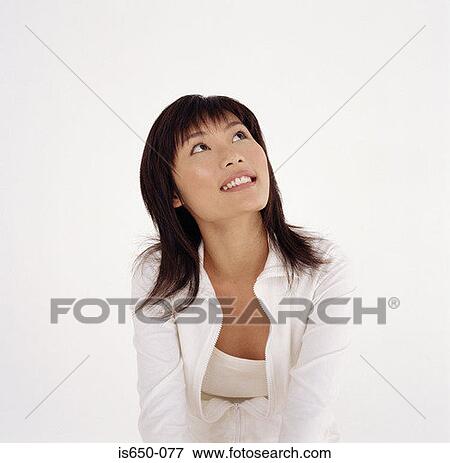 Young woman looking up View Large Photo Image Stock Photo - Young woman looking up. Fotosearch