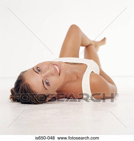 Young woman lying on her back View Large Photo Image Stock Photo - Young woman lying on her back. Fotosearch
