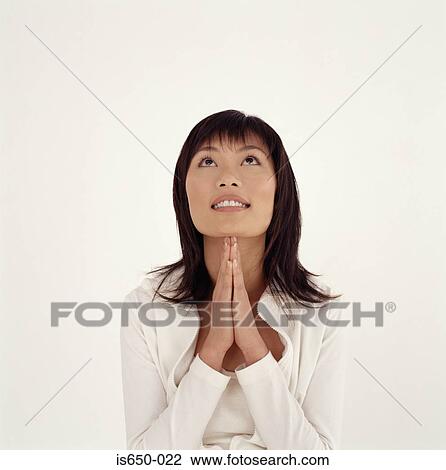 Young woman praying View Large Photo Image Stock Image - Young woman praying. Fotosearch