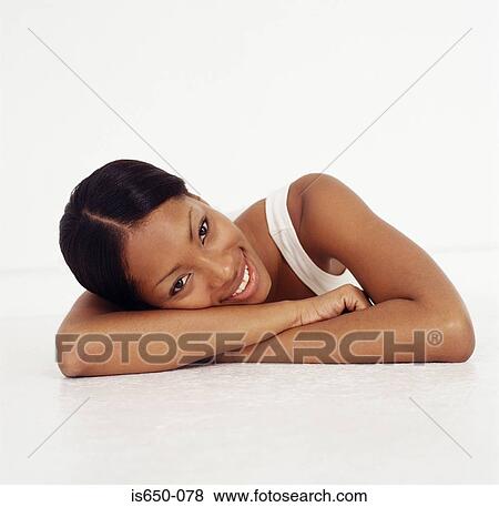 Young woman resting her head on her arms View Large Photo Image Stock Photo - Young woman resting her head on her arms. Fotosearch