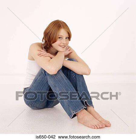 Young woman sitting down resting head on arms View Large Photo Image Stock Image - Young woman sitting down resting head on arms. Fotosearch