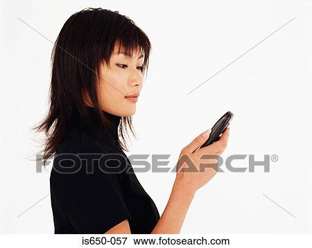 Young woman using mobile phone View Large Photo Image Stock Photo - Young woman using mobile phone. Fotosearch
