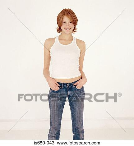 Stock Image - Young woman with hands in pockets. Fotosearch