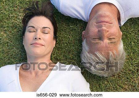 Couple asleep on the grass View Large Photo Image Stock Photo - Couple asleep on the grass. Fotosearch
