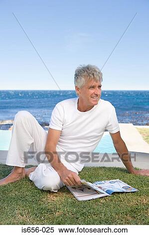 Man outside with magazine View Large Photo Image Stock Photography - Man outside with magazine. Fotosearch