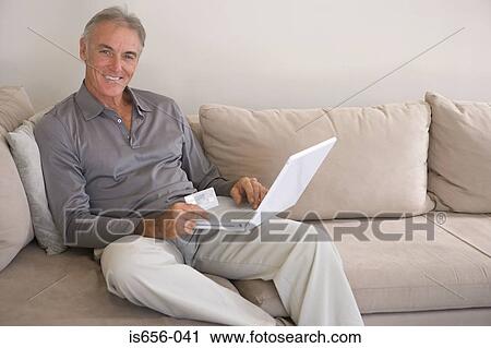 Man with laptop and credit card View Large Photo Image Stock Image - Man with laptop and credit card. Fotosearch